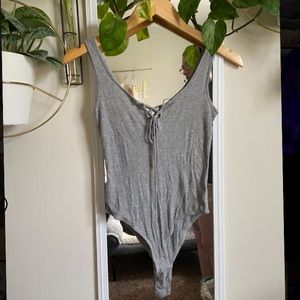 Tank top bodysuit with lace up v-neck